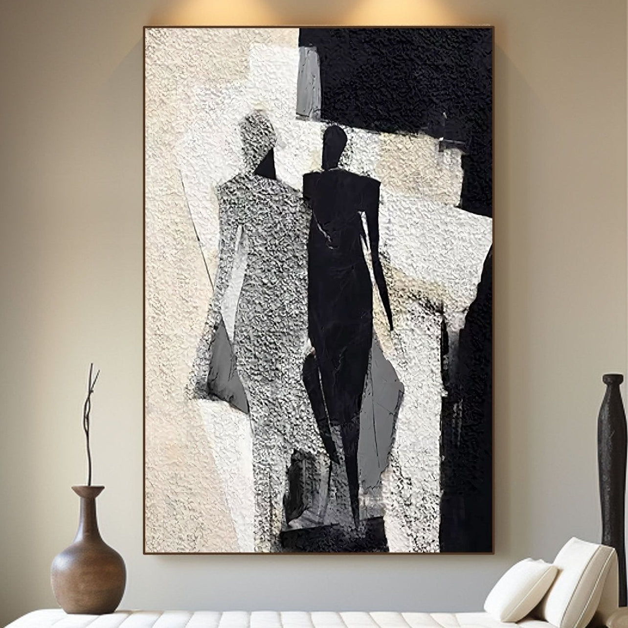 Abstract black and white painting on a wall above a bench.